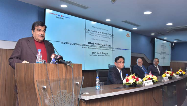 Nitin Gadkari addressing media at the signing of the MoA between the Delhi Police & Maruti Suzuki. Also present at the occasion were, L-R_ Kenichi Ayukawa, MD & CEO, Maruti Suzuki and others