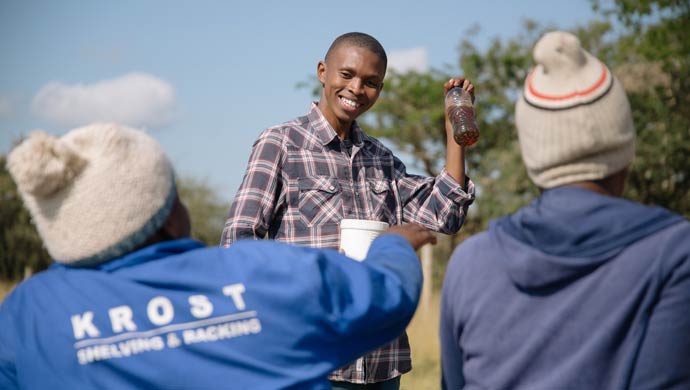 Thabang Mabapa seen showing his Castor Oil as Biodiesel with workers at Muila Village, Limpopo 